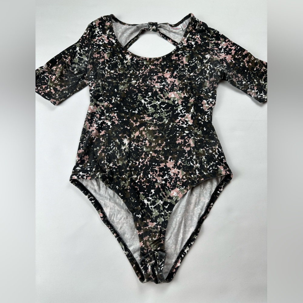 Bodysuit with fun splatter print and cutout/twist in back. Size L